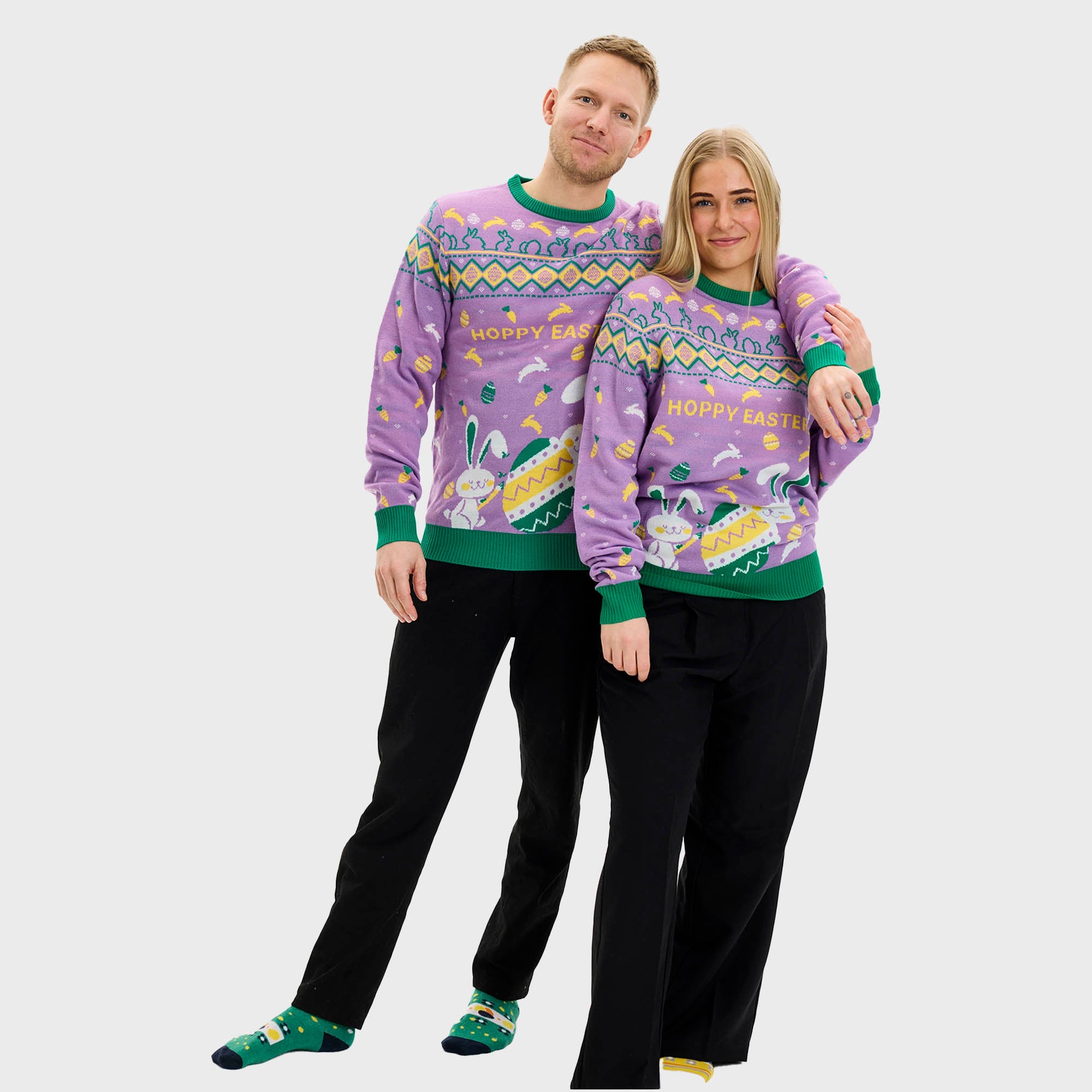 En man med ryggen vänd bär en lila påsktröja med påskägg och kaniner.