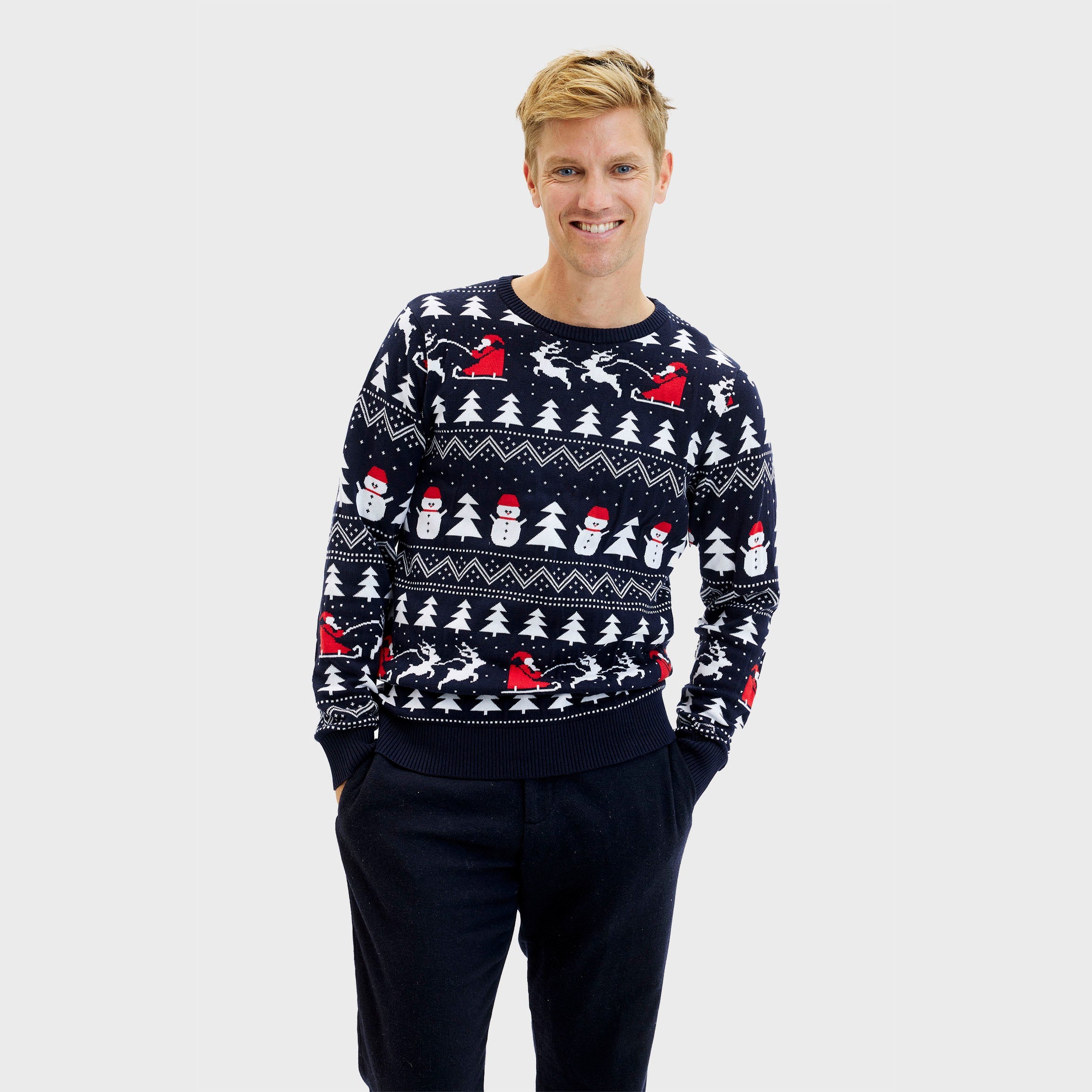 Man i mörkblå jultröja med julgranar och snögubbar.