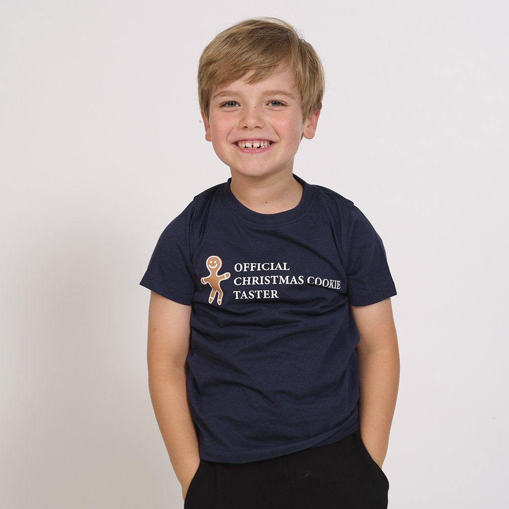 Ett barn som bär en svart T-shirt med en tårtgubbe på.